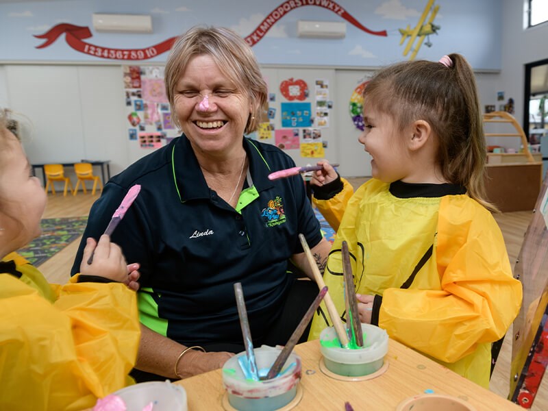 Two children playing with paint